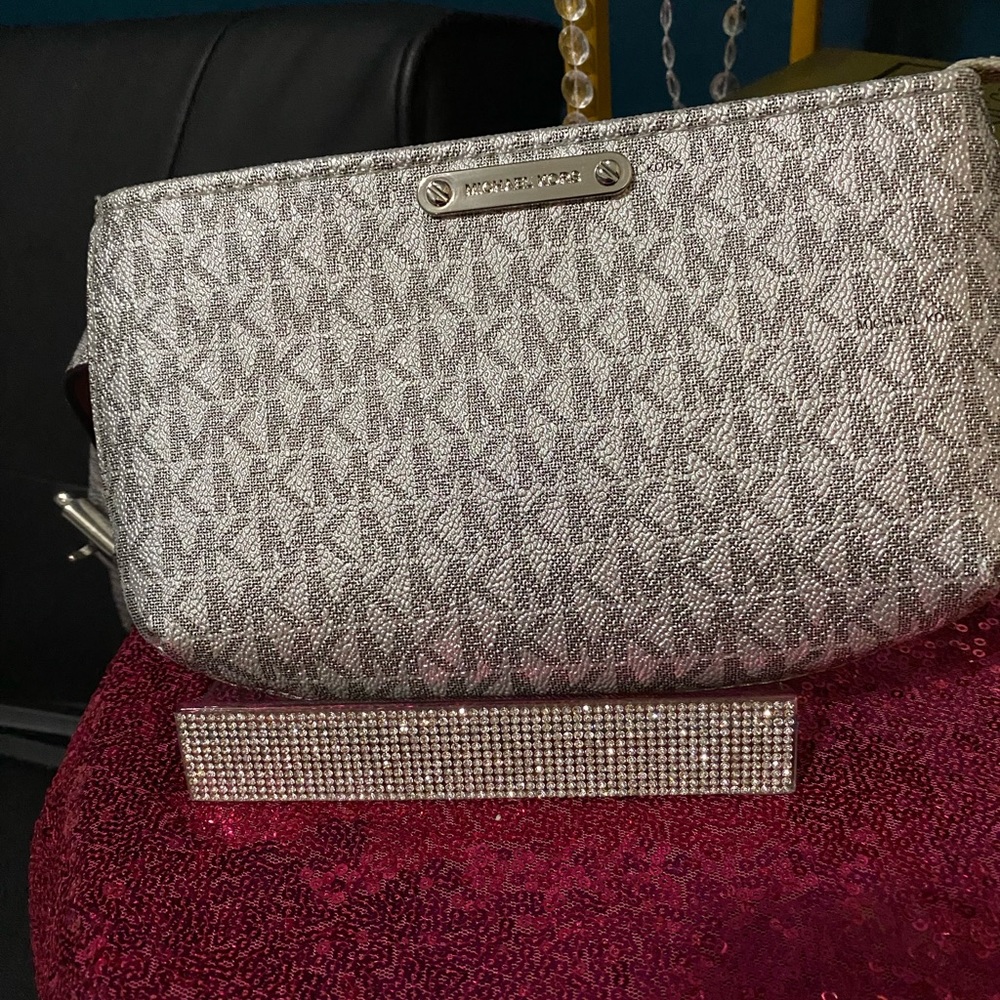 Michael Kors Logo Belt Bag Silver Color includes MK charm.